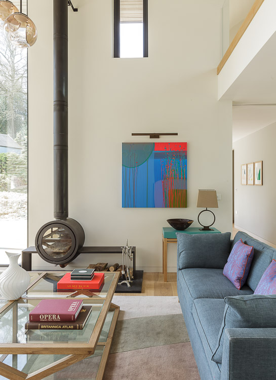 contemporary living room with wood burning stove and charlotte cornish painting