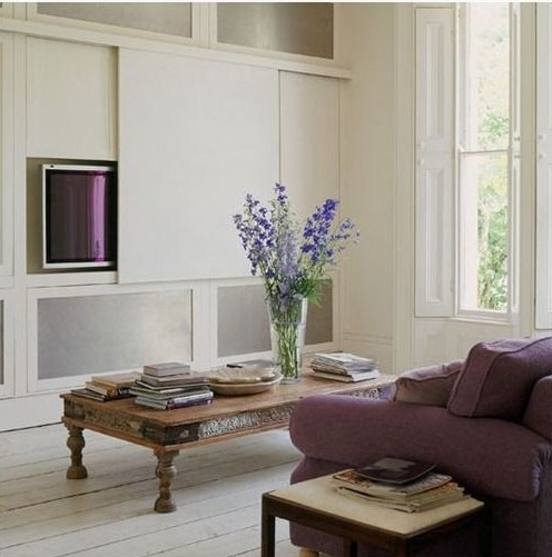 Sliding panel to hide a television in a sitting room scheme
