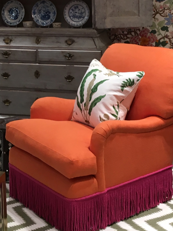 Orange armchair with hot pink fringe by Ben Pentreath for G P and J Baker